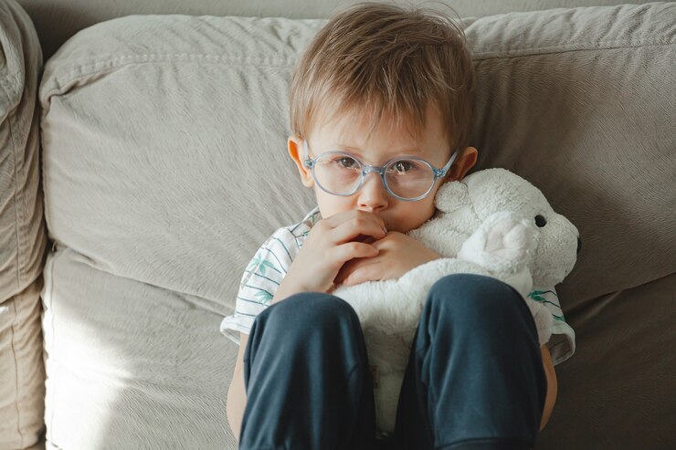 child-with-autism-glasses-sits-sofa-sad_266247-2453
